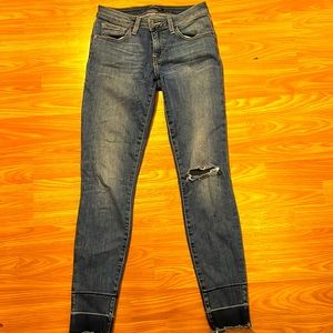 Lucky Skinny Jeans have a slit on left knee area came like that.